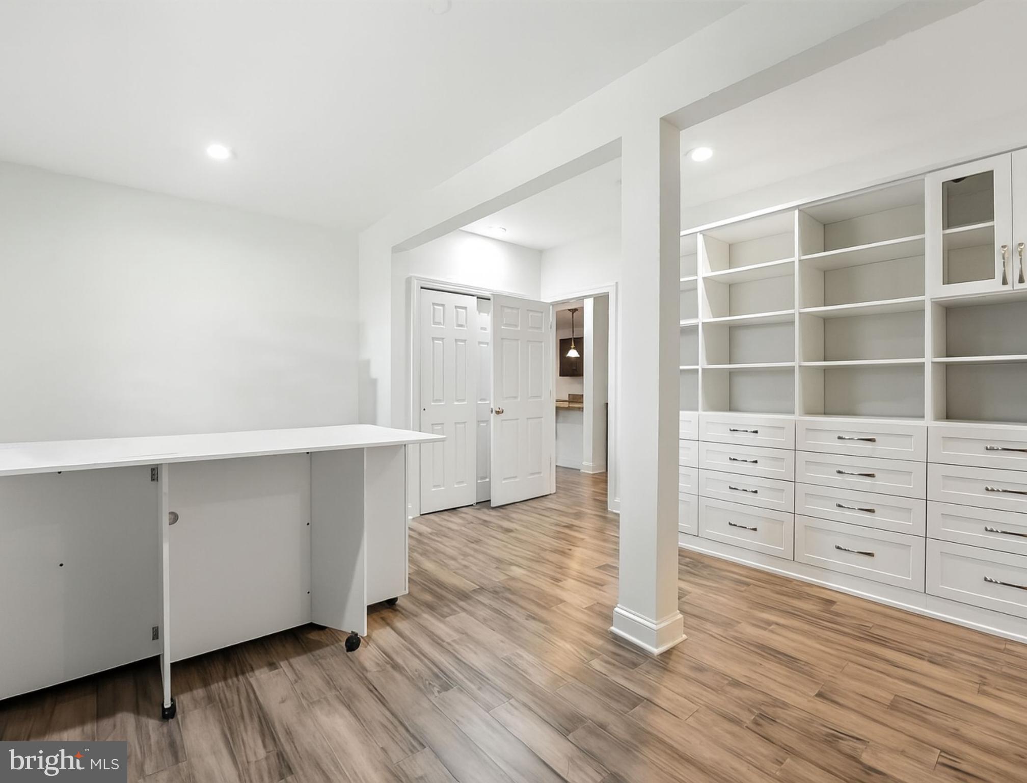 43152 Valiant Drive Chantilly, VA 20152 - Photo 30 of 44 a view of an empty room with wooden floor and cabinet