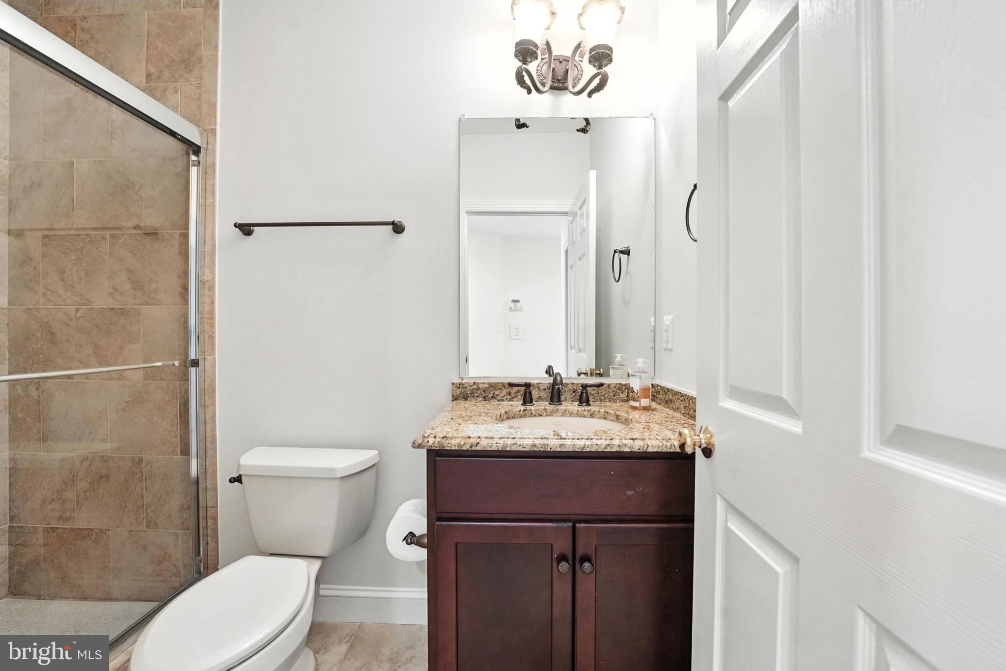 43152 Valiant Drive Chantilly, VA 20152 - Photo 31 of 44 a bathroom with a granite countertop sink toilet and mirror