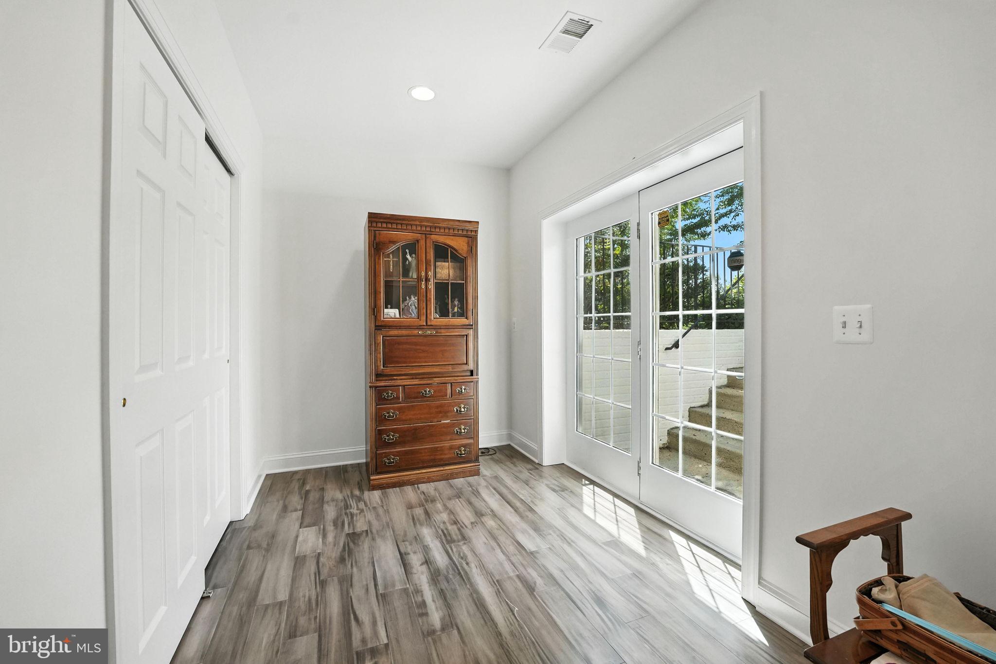 43152 Valiant Drive Chantilly, VA 20152 - Photo 33 of 44 an empty room with wooden floor and windows