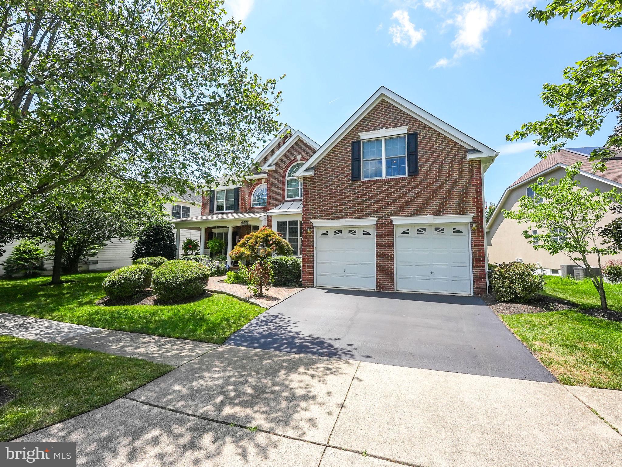 43152 Valiant Drive Chantilly, VA 20152 - Photo 44 of 44 a front view of a house with a yard and potted plants