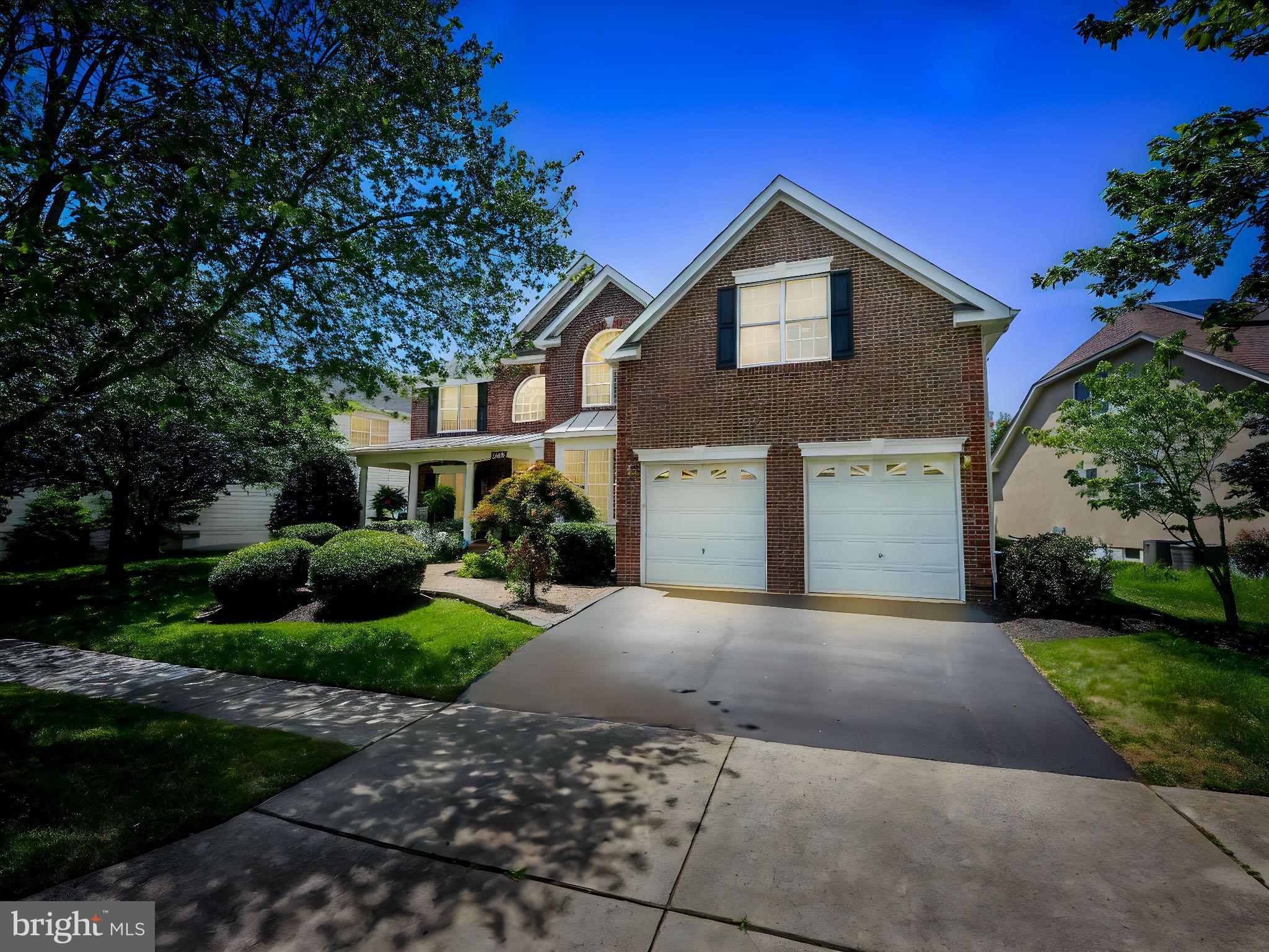 43152 Valiant Drive Chantilly, VA 20152 - Photo 7 of 44 a front view of a house with a yard and garage