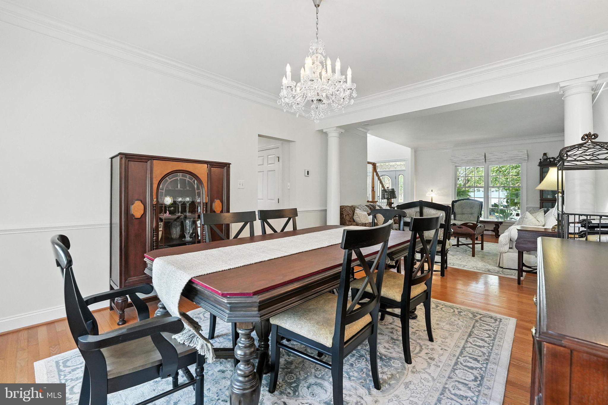 43152 Valiant Drive Chantilly, VA 20152 - Photo 9 of 44 a dining room with furniture a rug and a chandelier