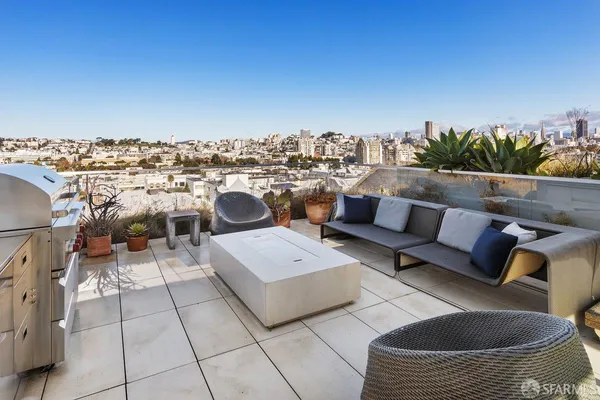a view of a terrace with couches and sky view
