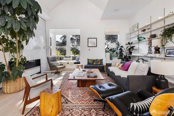 a living room with furniture and a potted plant