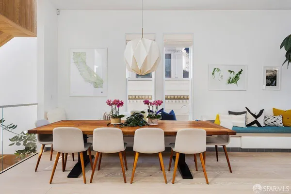 a view of a dining room with furniture and wooden floor