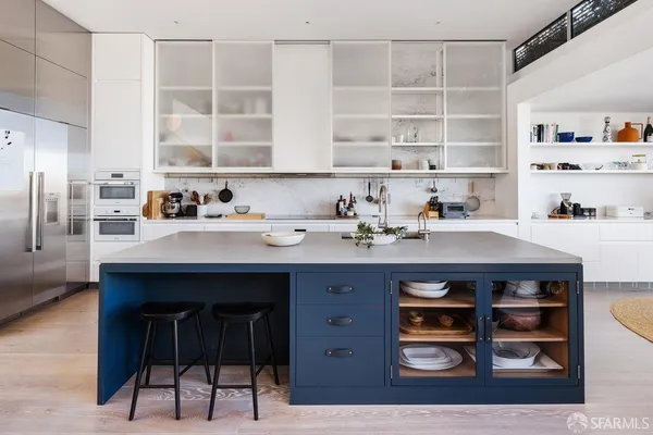 a kitchen with a wooden table and chairs
