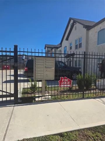 a view of street with wooden fence