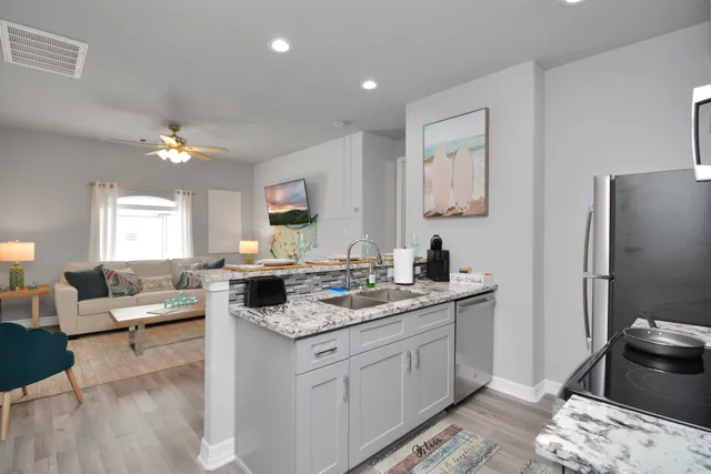 a kitchen with a stove a sink and a refrigerator