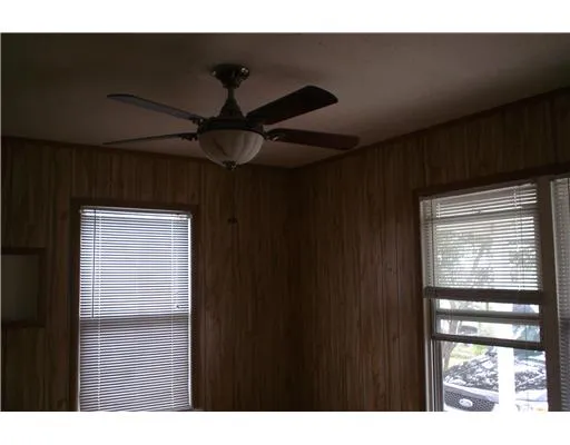 a picture of a room with a ceiling fan