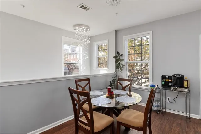 a view of a dining room with furniture and wooden floor