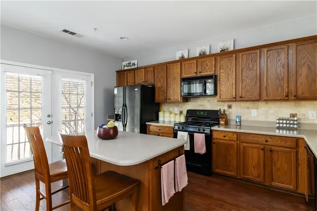 a kitchen with stainless steel appliances wooden cabinets and a stove top oven