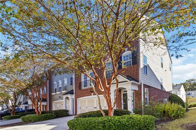 front view of a house with a tree