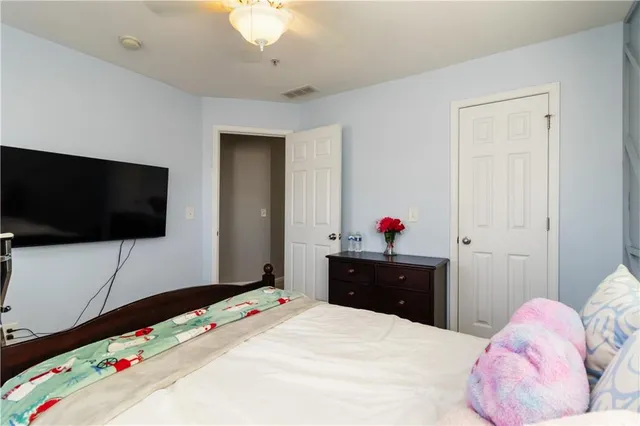 a bedroom with a bed and a flat screen tv