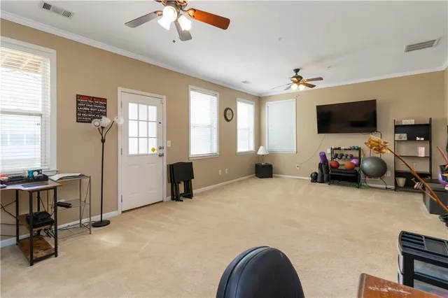 a view of a livingroom with workspace and a window