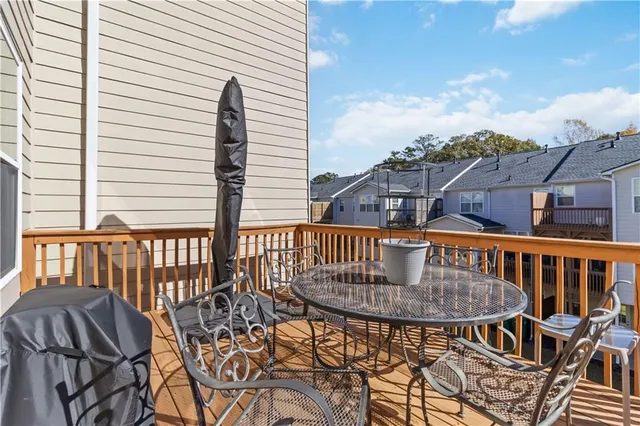 a view of balcony with a table and chairs