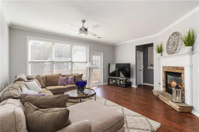 a living room with furniture a fireplace and a flat screen tv