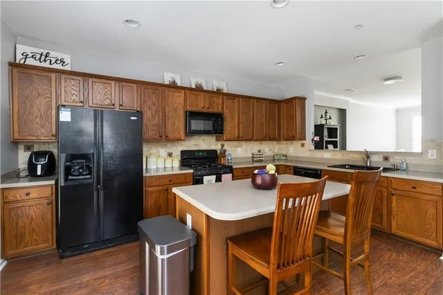 a kitchen with stainless steel appliances granite countertop a refrigerator stove microwave and sink
