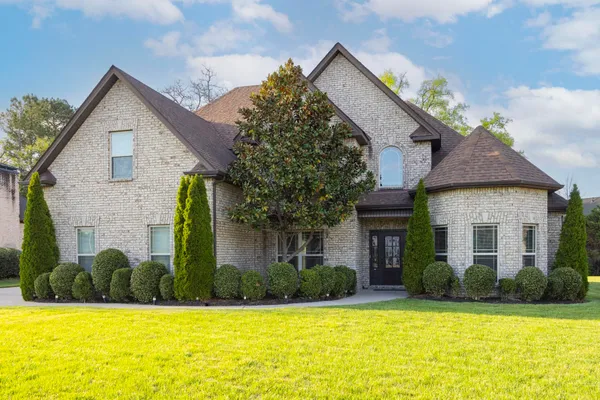 a front view of a house with a yard and garage