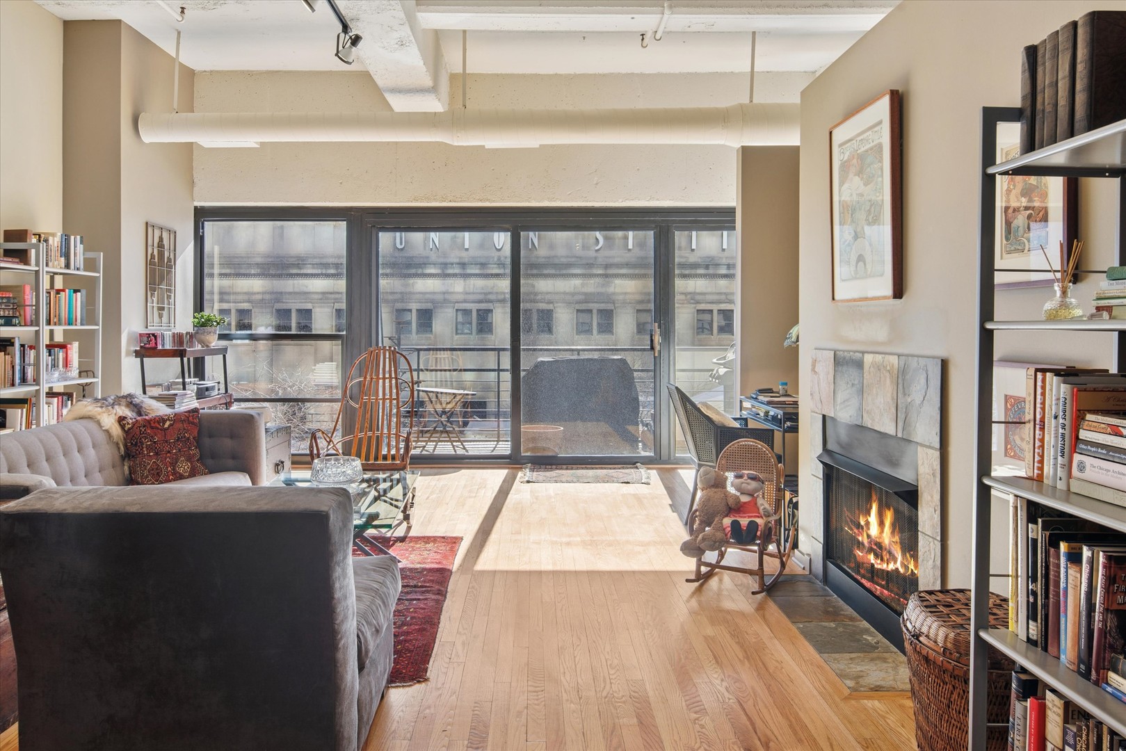130 South Canal Street, Unit 323 Chicago, IL 60606 - Photo 9 of 26 a living room with fireplace furniture and a floor to ceiling window