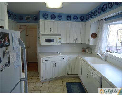 3 Ridge Lane Colonia, NJ 07067 - Photo 4 of 13 a kitchen with stainless steel appliances granite countertop a sink stove and cabinets
