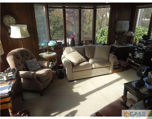3 Ridge Lane Colonia, NJ 07067 - Photo 5 of 13 a living room with furniture and a lamp