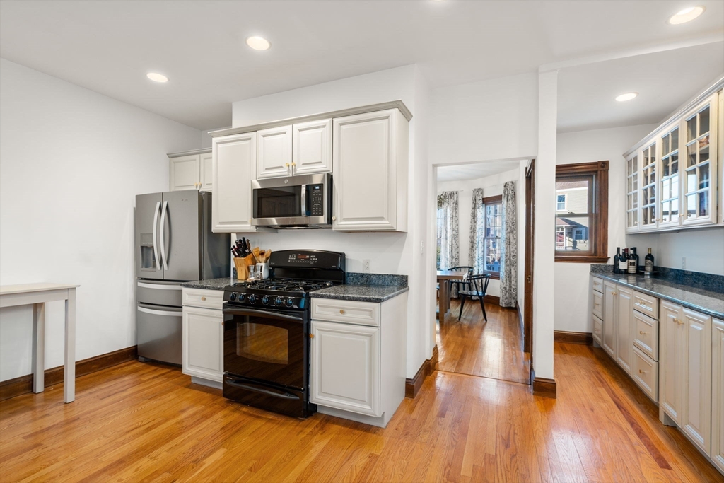 3 Ocean Street Boston, MA 02124 - Photo 19 of 42 a kitchen with a stove a refrigerator and a sink