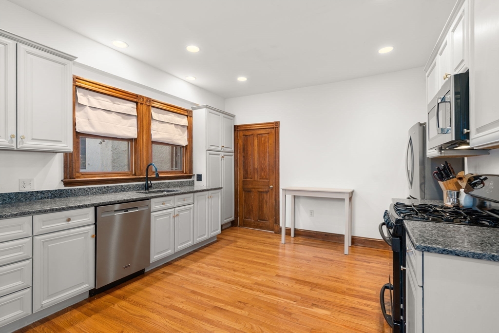 3 Ocean Street Boston, MA 02124 - Photo 20 of 42 a large kitchen with granite countertop a stove and a sink