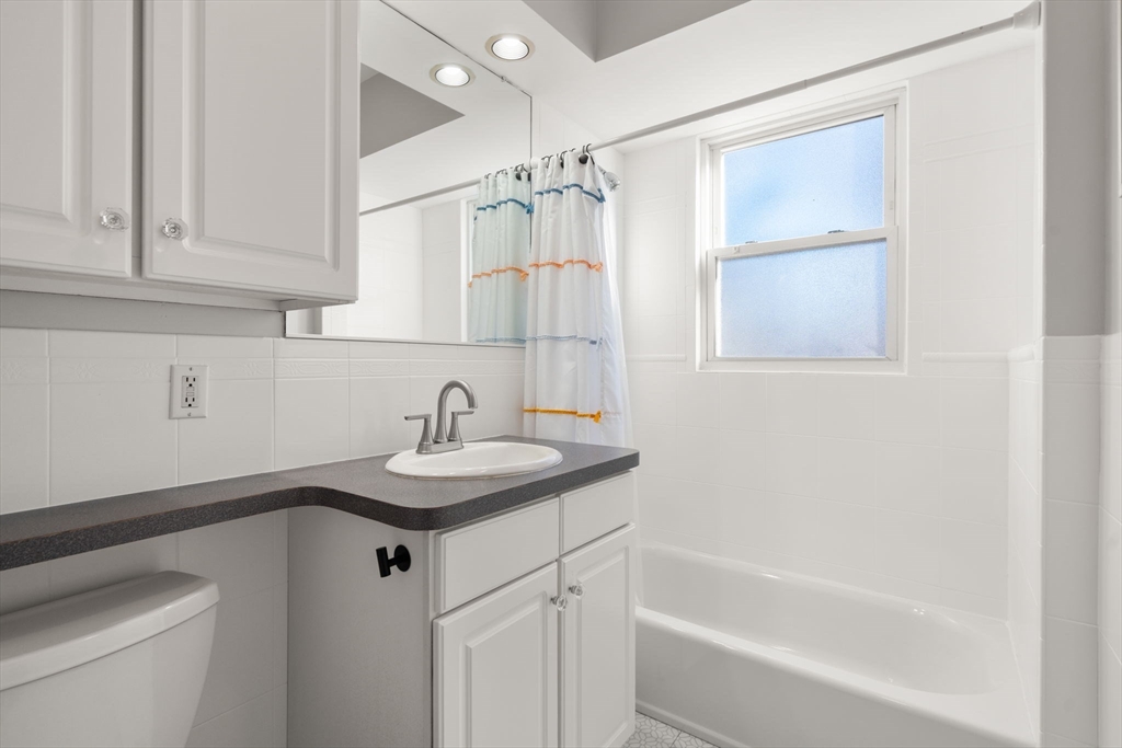 3 Ocean Street Boston, MA 02124 - Photo 33 of 42 a bathroom with a sink a vanity and a bathtub