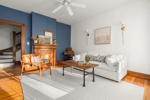 a living room with furniture and a lamp