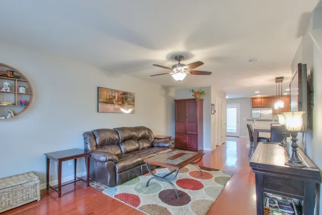 a living room with furniture and a chandelier