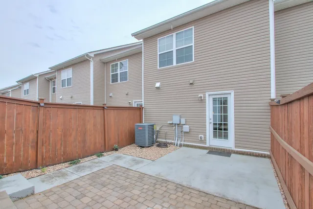 a backyard of a house with barbeque oven and outdoor seating