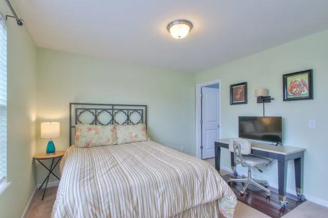 a bedroom with a bed and a flat screen tv