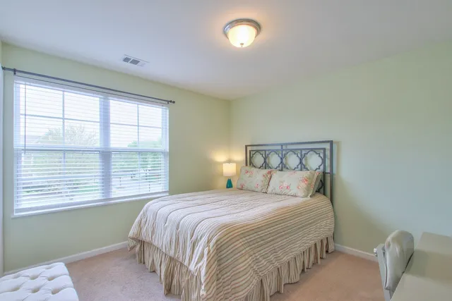 a bedroom with a bed and a chair