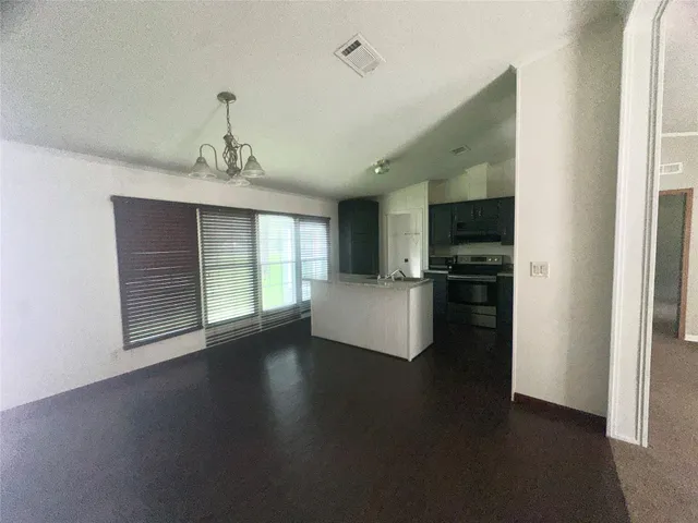 a view of a kitchen with a sink dishwasher and a refrigerator