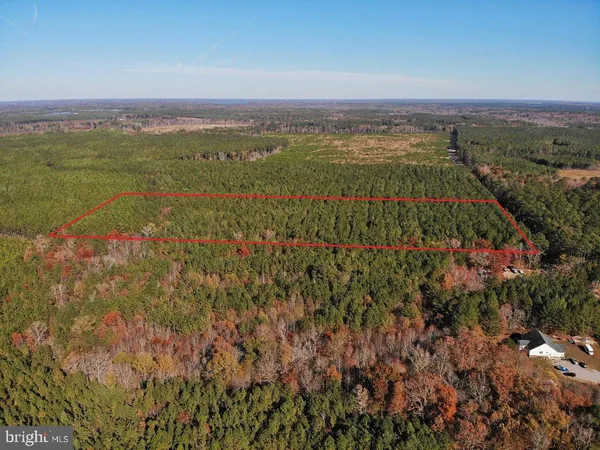 an aerial view of a houses with a yard