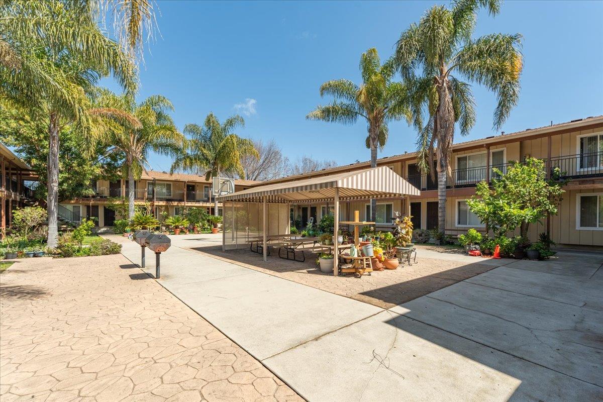 1760 Bay Road East Palo Alto, CA 94303 - Photo 5 of 8 a view of a patio with a table and chairs under an umbrella
