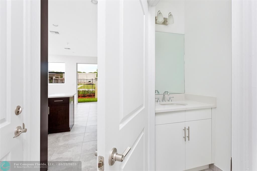 6965 Pines Circle, Unit 29 Pompano Beach, FL 33073 - Photo 15 of 27 a bathroom with a sink and mirror