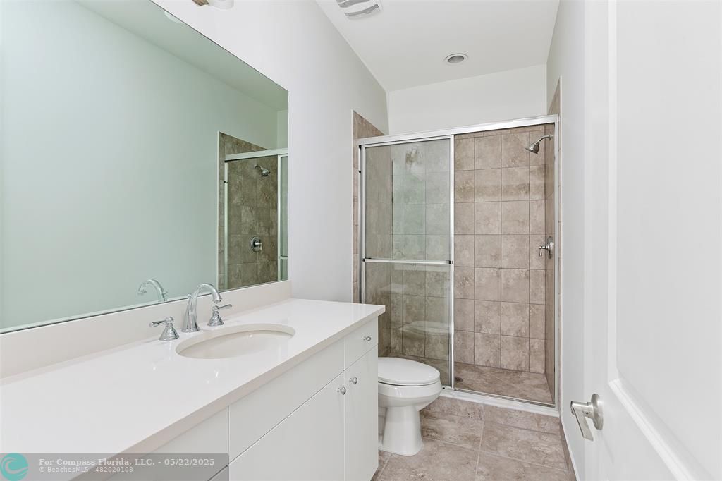 6965 Pines Circle, Unit 29 Pompano Beach, FL 33073 - Photo 19 of 27 a bathroom with a granite countertop sink toilet and shower