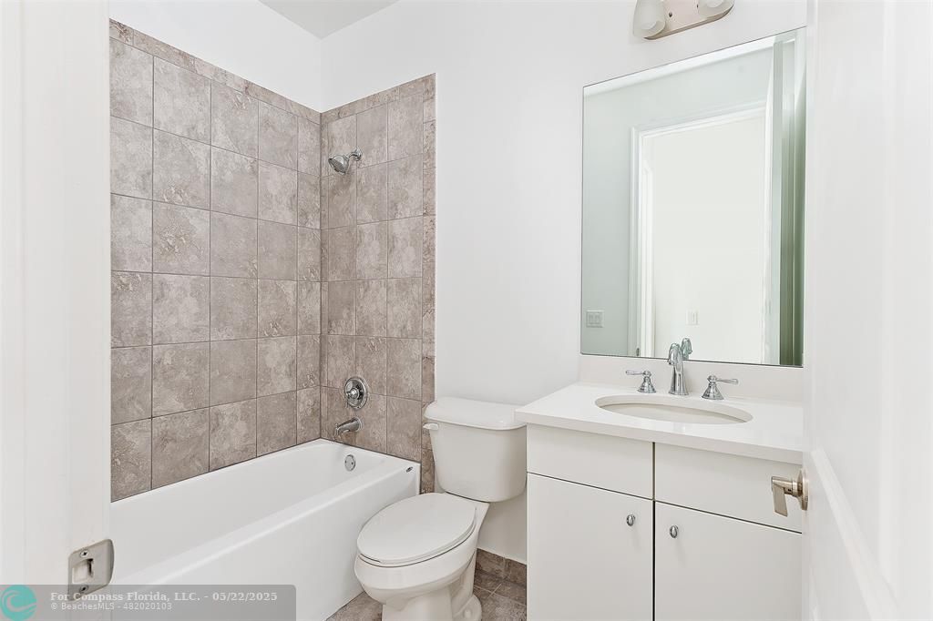 6965 Pines Circle, Unit 29 Pompano Beach, FL 33073 - Photo 22 of 27 a bathroom with a sink a toilet and shower