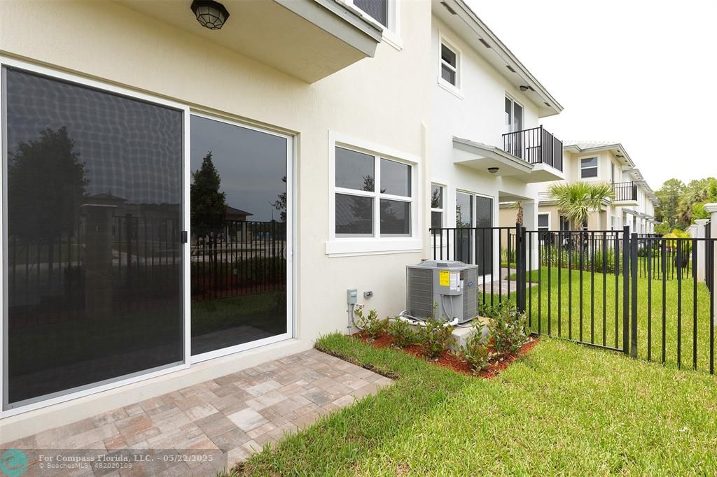 6965 Pines Circle, Unit 29 Pompano Beach, FL 33073 - Photo 27 of 27 a view of a house with a yard and pathway
