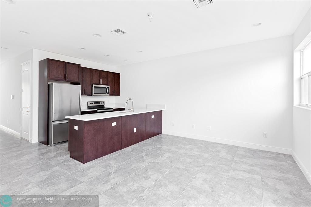 6965 Pines Circle, Unit 29 Pompano Beach, FL 33073 - Photo 5 of 27 a kitchen with a refrigerator stove and microwave