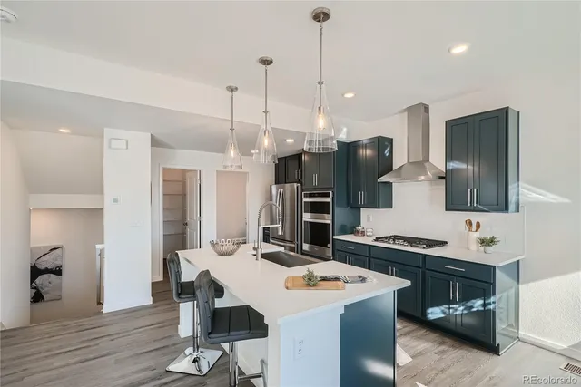 a kitchen with a sink a counter space and stainless steel appliances