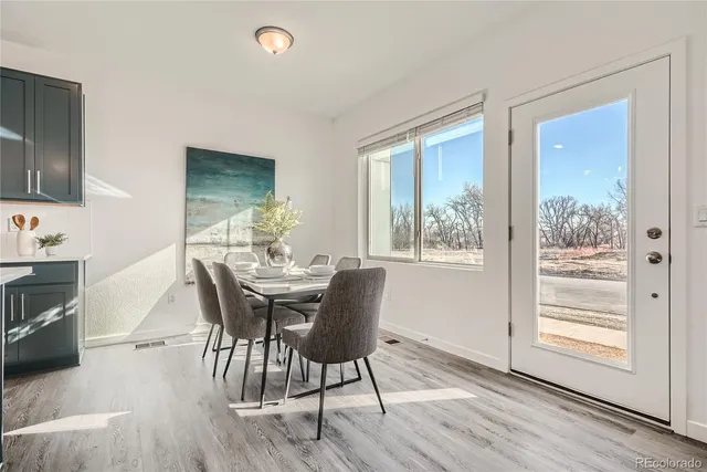 a large kitchen with a table and chairs