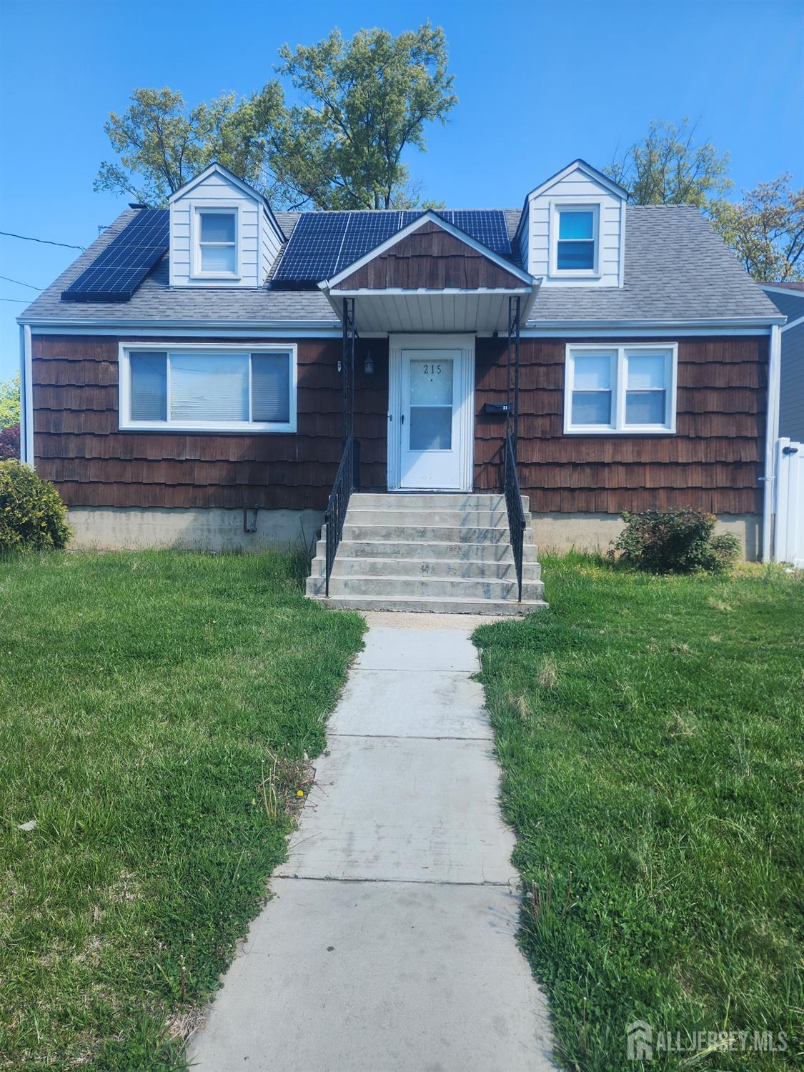 215 Summit Avenue Fords, NJ 08863 - Photo 1 of 15 a front view of a house with garden