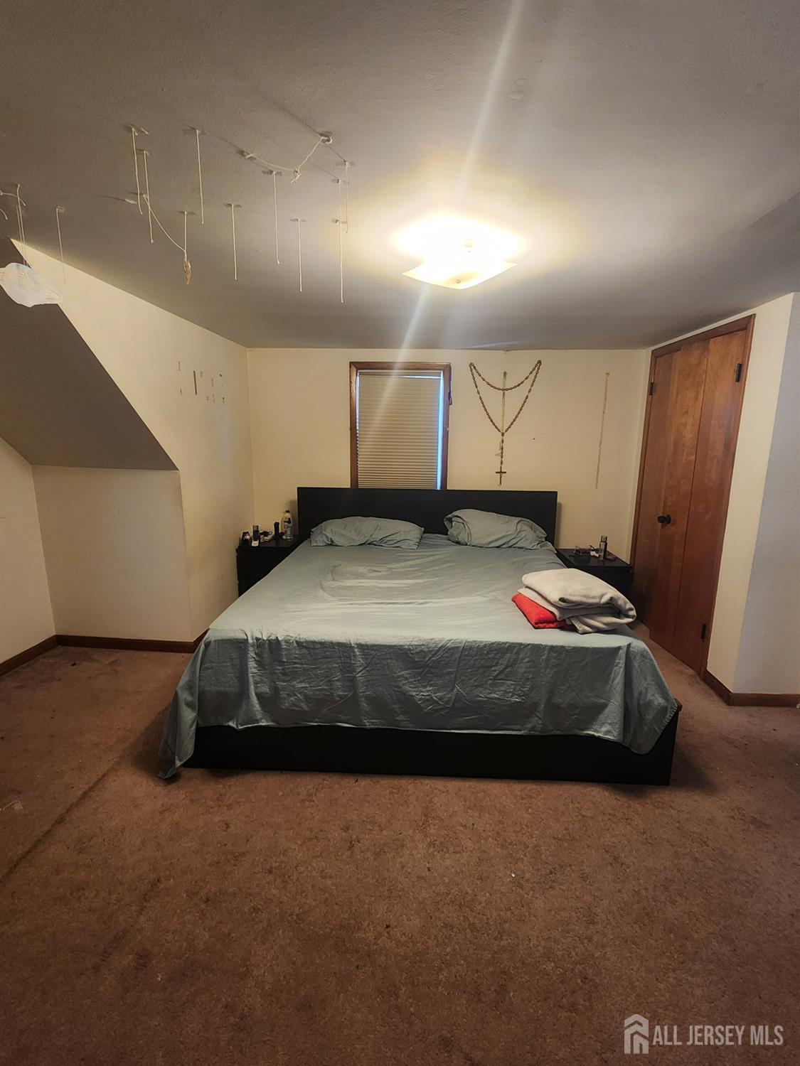 215 Summit Avenue Fords, NJ 08863 - Photo 11 of 15 a bedroom with a bed and a mirror