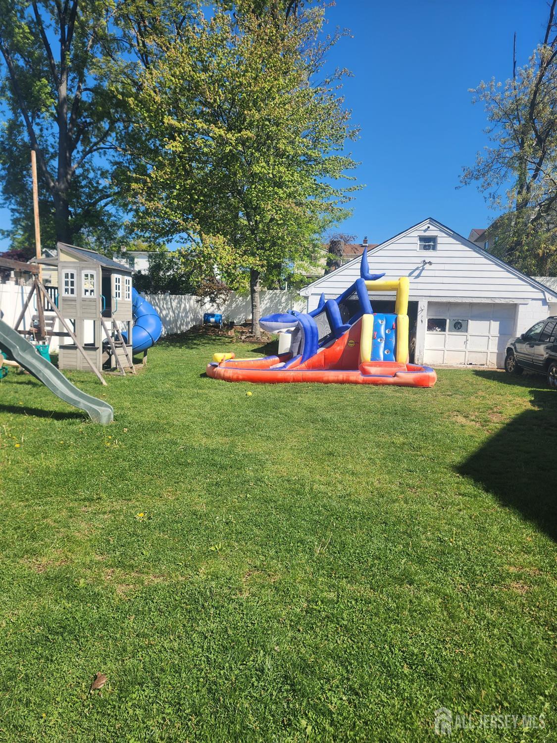 215 Summit Avenue Fords, NJ 08863 - Photo 2 of 15 a white house with a big yard and large trees