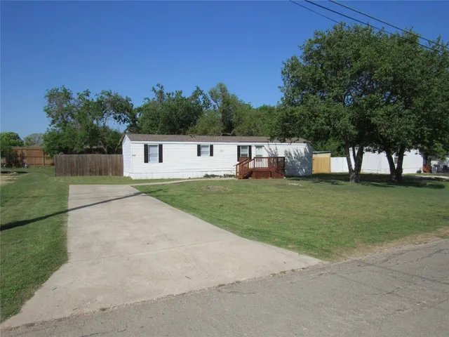 a house view with a play ground in front of it
