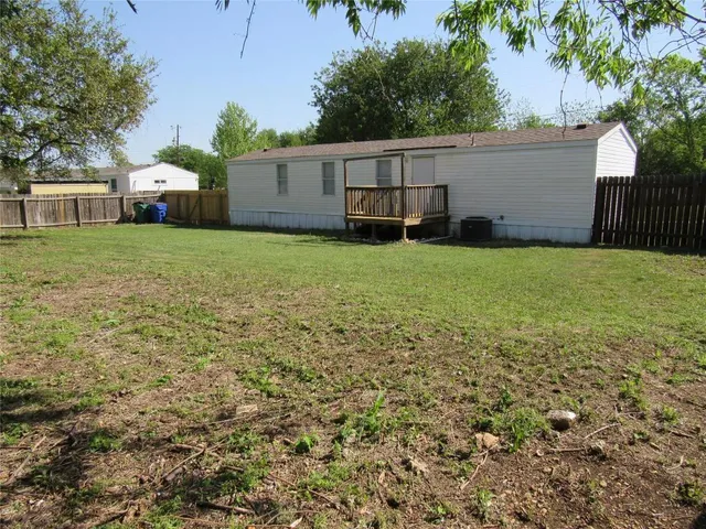 a front view of a house with a garden and deck