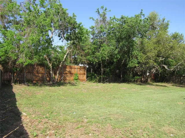 a backyard of a house with trees and slides