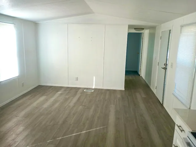 an empty room with wooden floor and closet